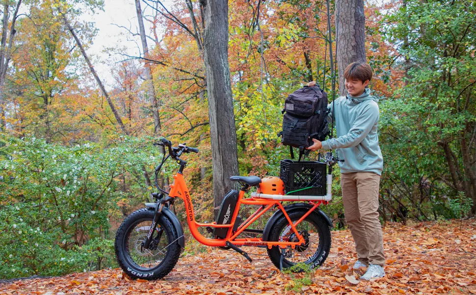 A man goes on an adventure on an M-81 cargo e-bike, loaded with fishing equipment.